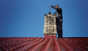 Chimney Sweep Performing Cleaning