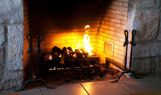 Fire in Stone and Brick Fireplace