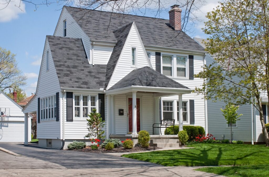 White Home With Steep Roofline and Chimney