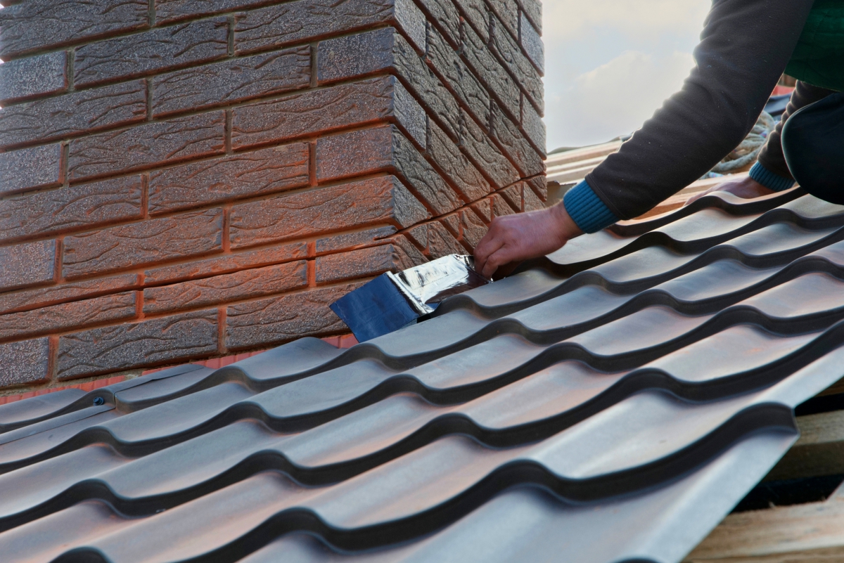Man Installing Flashing Around Chimney