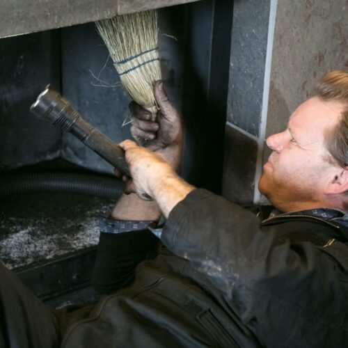 man inspecting chimney