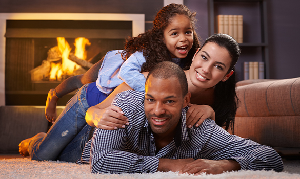 a family hanging out in front of a fireplace