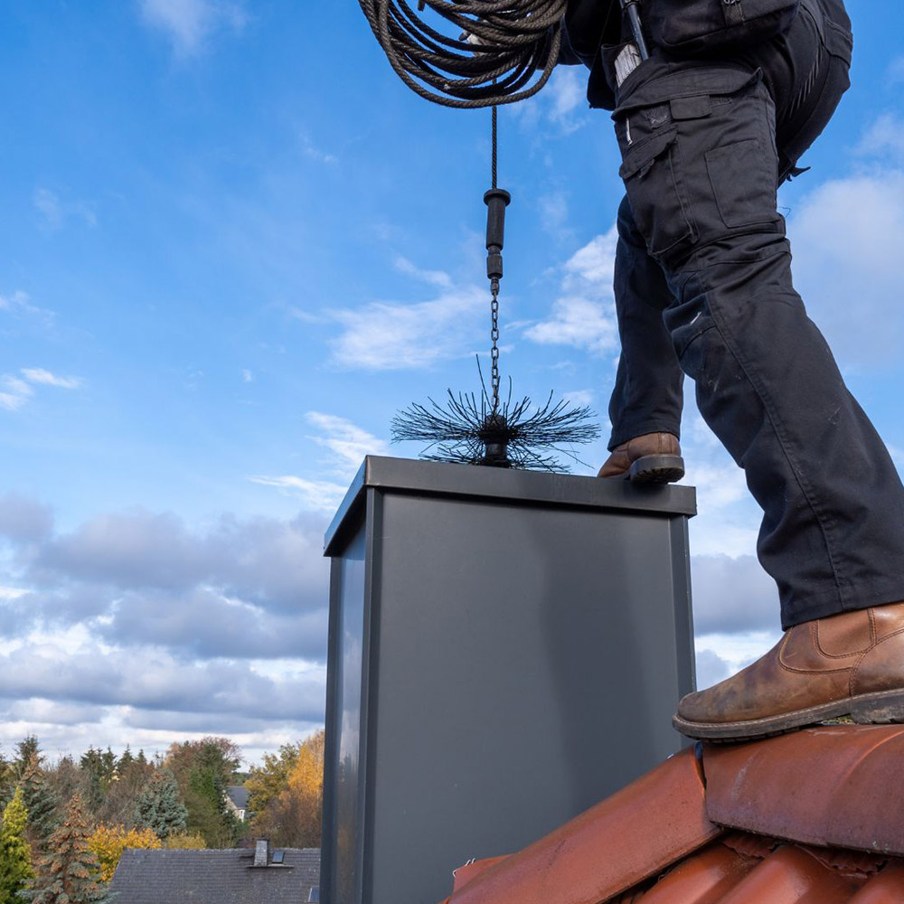 a person sweeping a chimney