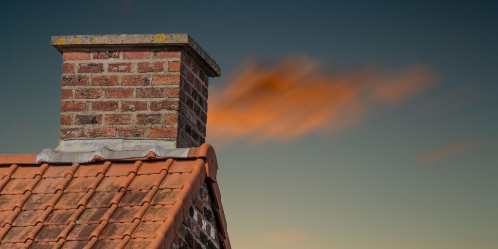 A house with a chimney during sunset