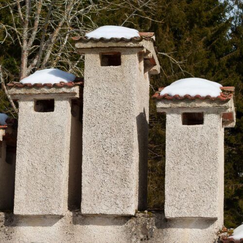 Three chimneys with flue caps
