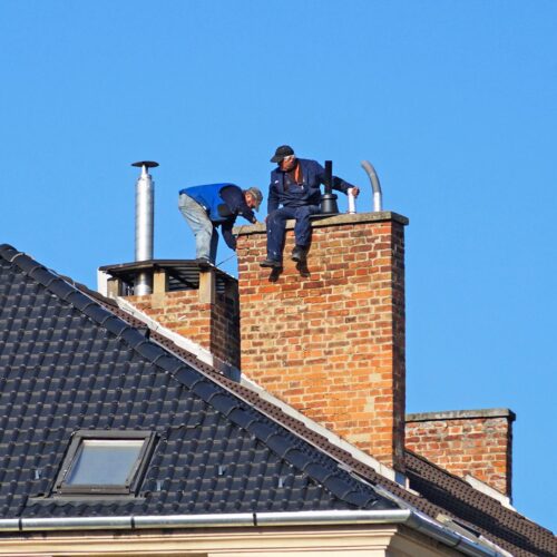 Workers repairing a chimney