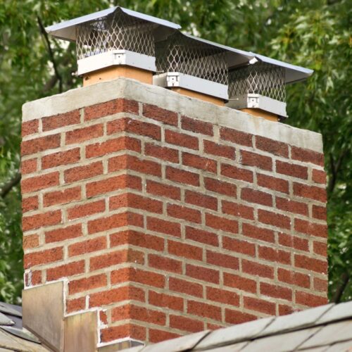 A large chimney with three chimney caps