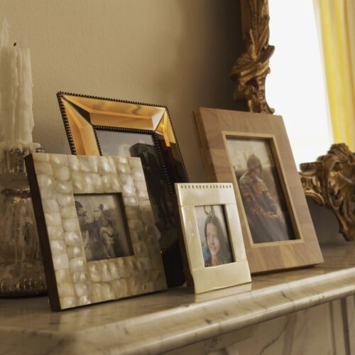 various photos sitting on a mantel