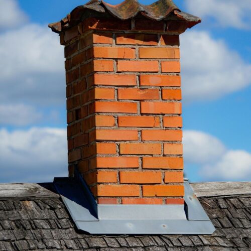 Brick chimney on a roof