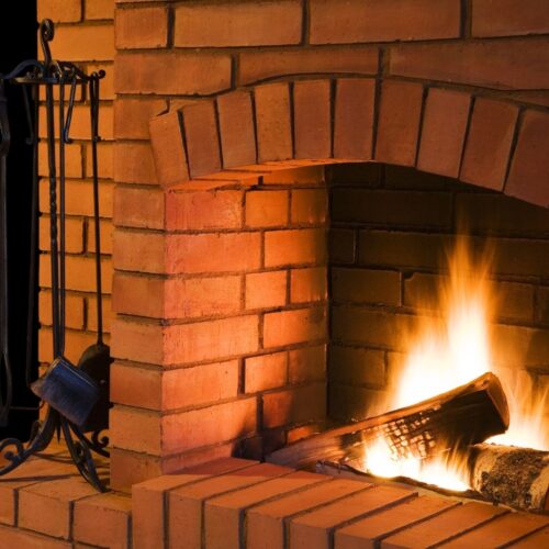 Brick chimney with wood burning inside of it